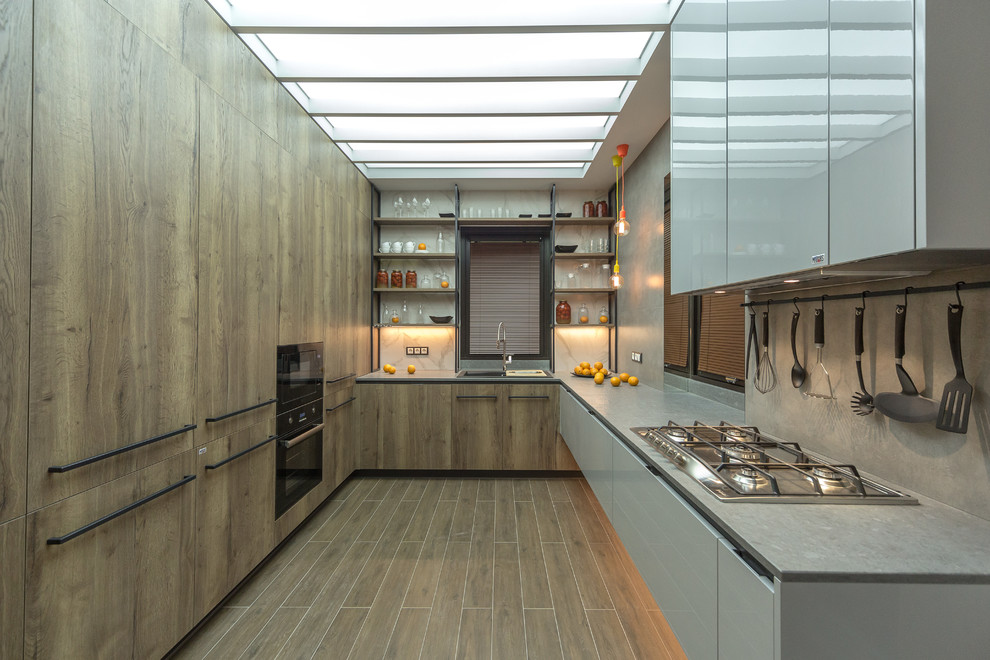 Photo of a contemporary u-shaped kitchen in Moscow with grey splashback, no island, flat-panel cabinets, medium wood cabinets, black appliances and medium hardwood flooring.