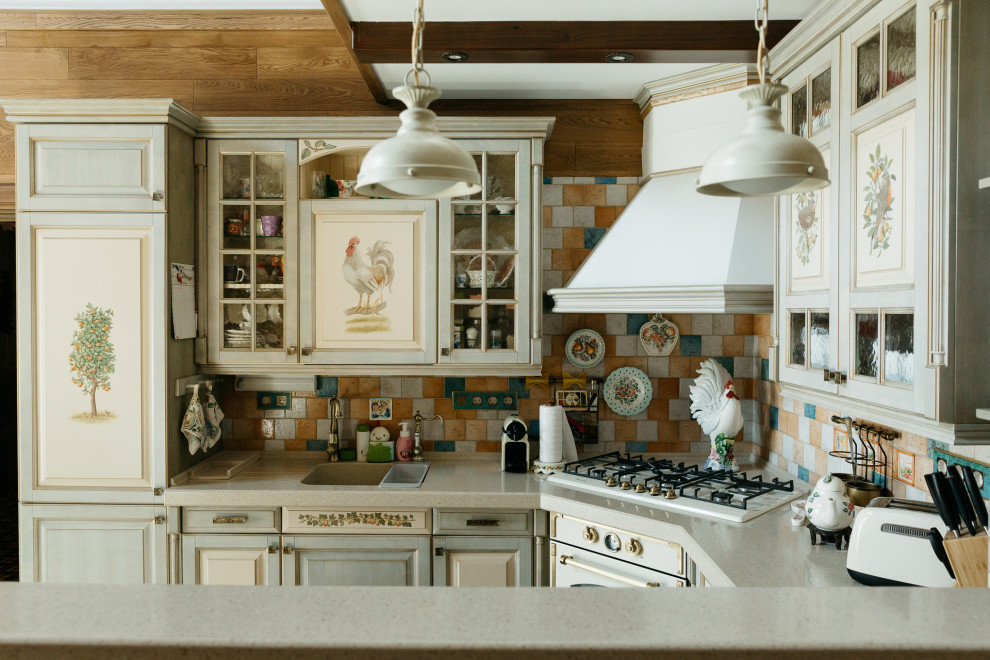 Inspiration for a large farmhouse u-shaped kitchen/diner in Moscow with raised-panel cabinets, green cabinets, composite countertops, mosaic tiled splashback, ceramic flooring, a breakfast bar, beige worktops and exposed beams.