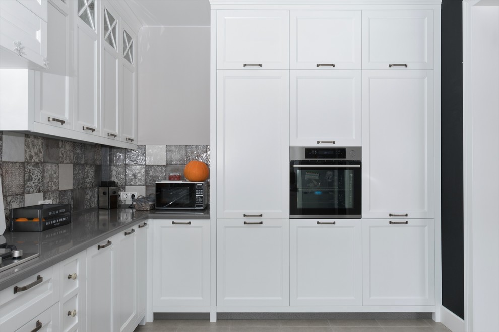 Photo of a large scandi u-shaped kitchen/diner in Moscow with an integrated sink, recessed-panel cabinets, white cabinets, composite countertops, grey splashback, ceramic splashback, stainless steel appliances, ceramic flooring, no island, grey floors and grey worktops.