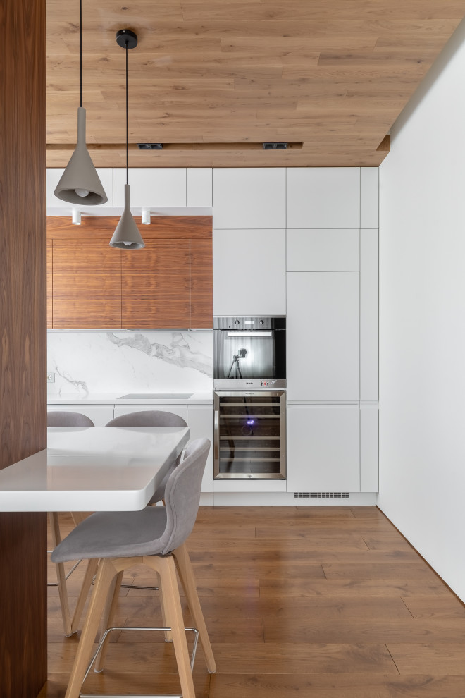 Example of a transitional dark wood floor and brown floor kitchen design in Moscow with brown backsplash and white countertops