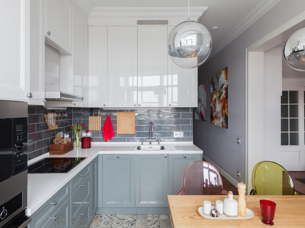 Trendy l-shaped multicolored floor eat-in kitchen photo in Moscow with an undermount sink, recessed-panel cabinets, white cabinets, subway tile backsplash, no island, white countertops, gray backsplash and stainless steel appliances