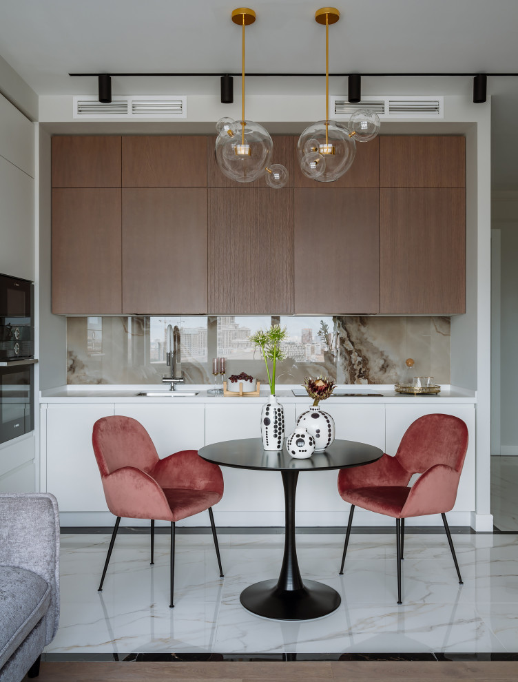 Photo of a contemporary l-shaped open plan kitchen in Moscow with a submerged sink, flat-panel cabinets, medium wood cabinets, beige splashback, black appliances, white floors and white worktops.