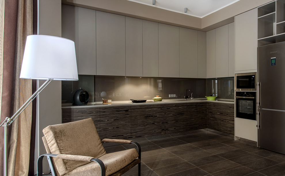 Photo of a contemporary l-shaped open plan kitchen in Moscow with a submerged sink, flat-panel cabinets, brown splashback, stainless steel appliances, no island and brown floors.