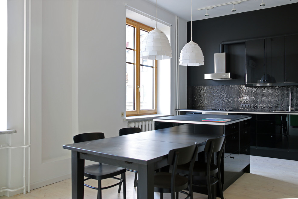 Small trendy galley light wood floor open concept kitchen photo in Moscow with a drop-in sink, flat-panel cabinets, black cabinets, laminate countertops, black backsplash, mosaic tile backsplash, stainless steel appliances and an island