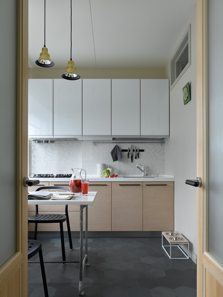 Photo of a modern enclosed kitchen in Moscow with a submerged sink, flat-panel cabinets, white cabinets, white splashback, mosaic tiled splashback, no island, grey floors and white worktops.