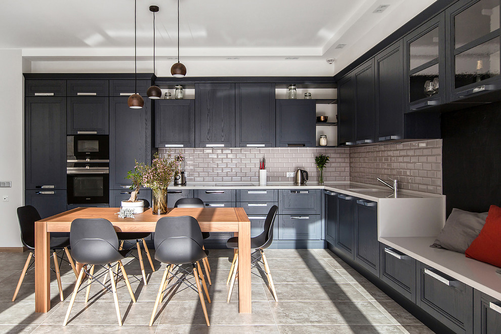 Contemporary l-shaped kitchen in Moscow with recessed-panel cabinets, black cabinets, beige splashback, metro tiled splashback, stainless steel appliances, no island and grey floors.