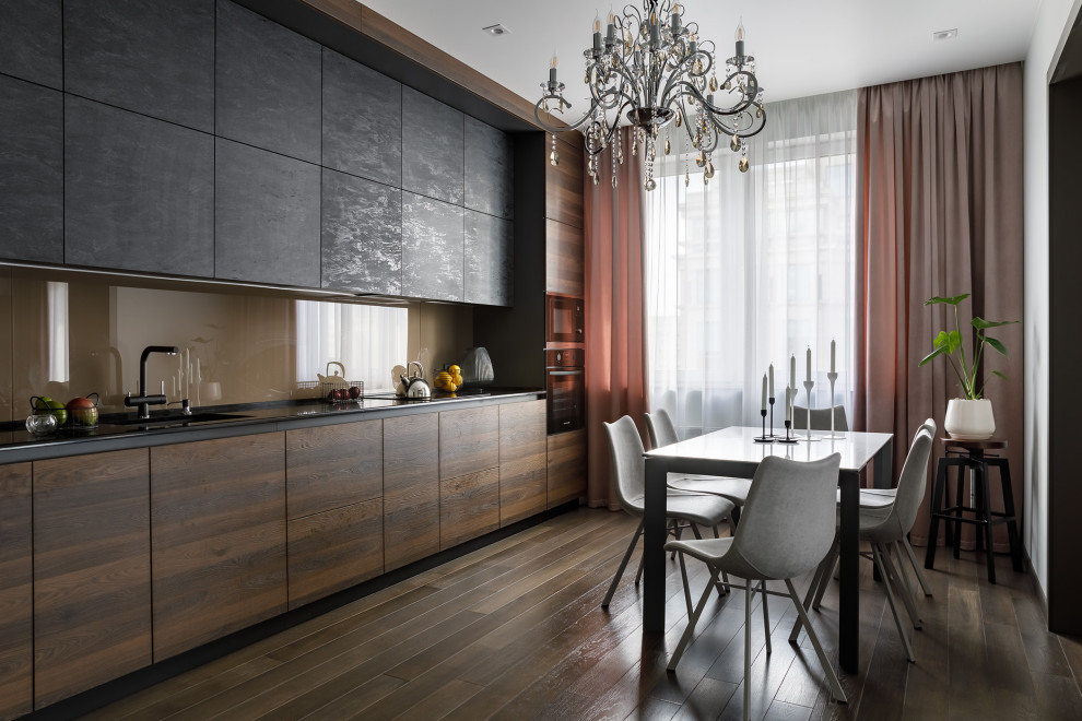 Design ideas for a contemporary single-wall kitchen/diner in Saint Petersburg with a submerged sink, flat-panel cabinets, dark wood cabinets, engineered stone countertops, beige splashback, glass sheet splashback, black appliances, medium hardwood flooring, no island, brown floors, black worktops and a drop ceiling.