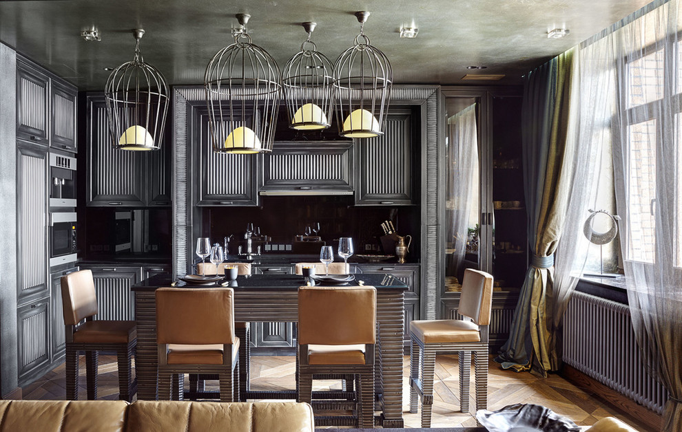 This is an example of a bohemian kitchen in Moscow with black cabinets, medium hardwood flooring and an island.