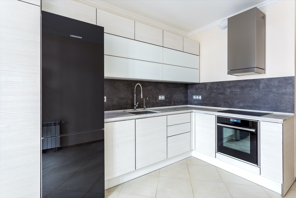 Inspiration for a medium sized contemporary l-shaped enclosed kitchen in Moscow with a submerged sink, flat-panel cabinets, white cabinets, engineered stone countertops, stone slab splashback, black appliances, no island, grey splashback, beige floors and ceramic flooring.