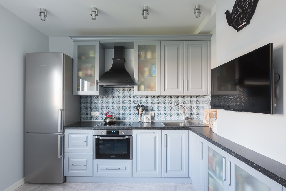 Design ideas for a contemporary l-shaped enclosed kitchen in Moscow with raised-panel cabinets, white cabinets, grey splashback, mosaic tiled splashback, stainless steel appliances and no island.
