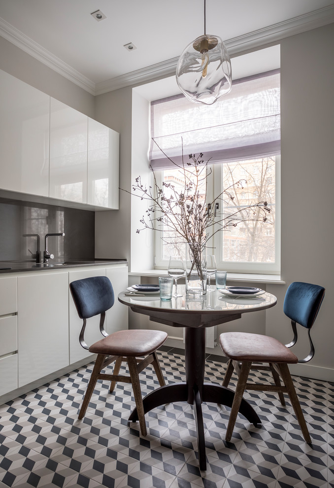 Inspiration for a contemporary enclosed kitchen in Moscow with a submerged sink, flat-panel cabinets, white cabinets, grey splashback, multi-coloured floors and grey worktops.
