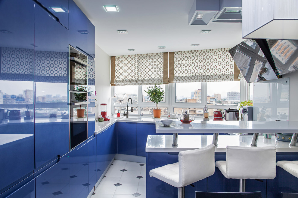 Photo of a large contemporary u-shaped open plan kitchen in Moscow with an integrated sink, flat-panel cabinets, blue cabinets, engineered stone countertops, white splashback, integrated appliances, ceramic flooring, a breakfast bar and window splashback.