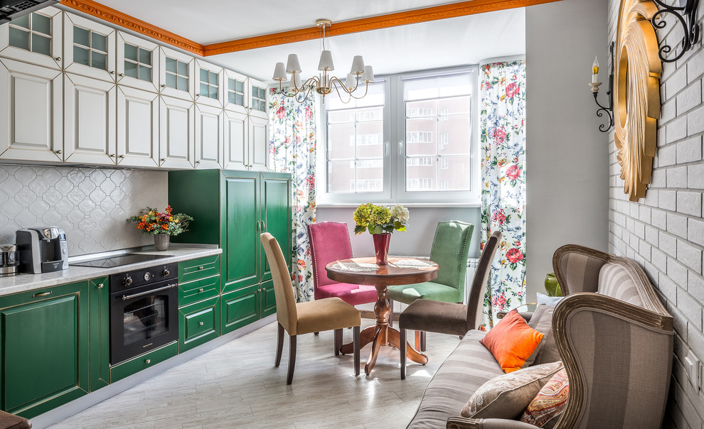 Design ideas for a small eclectic single-wall open plan kitchen with raised-panel cabinets, green cabinets, white splashback, black appliances, no island, grey floors and white worktops.