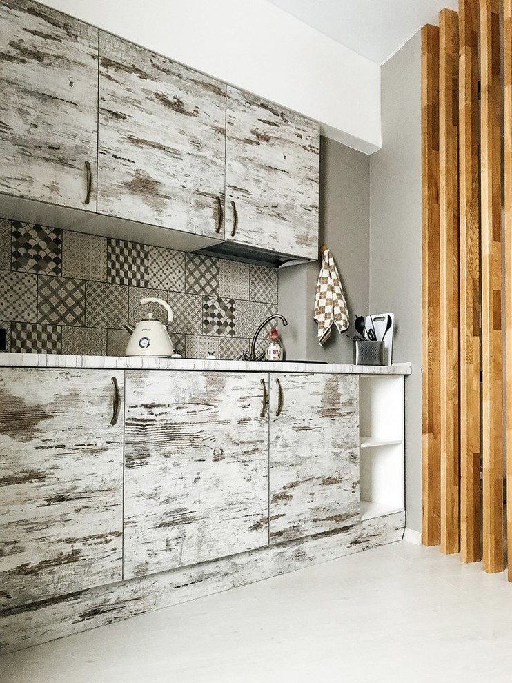 This is an example of an urban kitchen in Other with distressed cabinets.