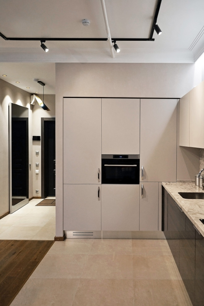 Example of a mid-sized urban l-shaped ceramic tile, beige floor and tray ceiling eat-in kitchen design in Moscow with an undermount sink, flat-panel cabinets, dark wood cabinets, solid surface countertops, beige backsplash, stainless steel appliances, no island, beige countertops and quartz backsplash