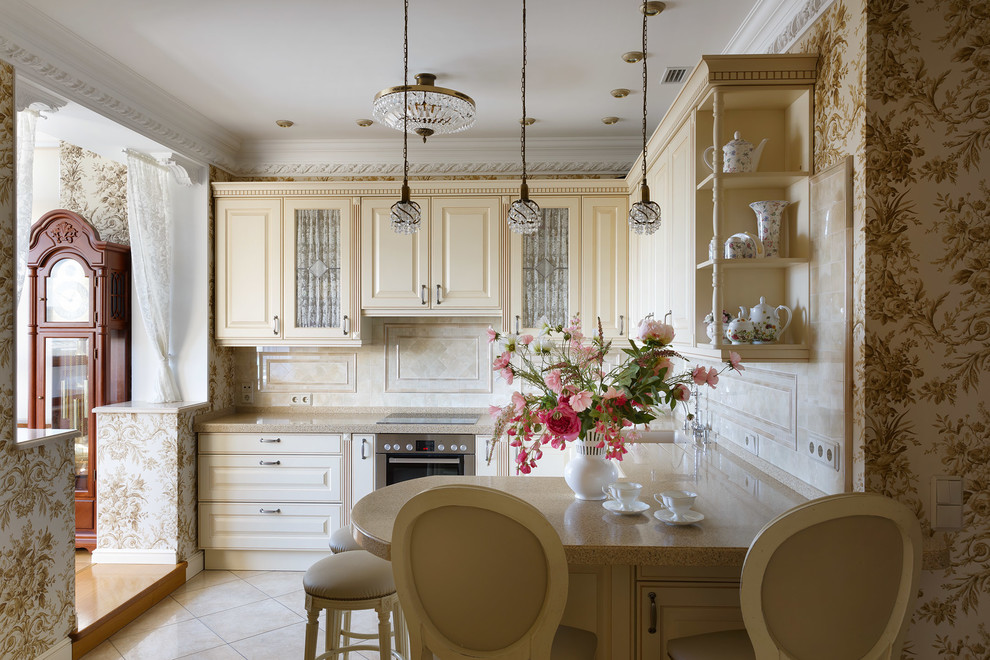 This is an example of a classic u-shaped enclosed kitchen in Saint Petersburg with raised-panel cabinets, beige cabinets, beige splashback, stainless steel appliances, a breakfast bar and beige floors.