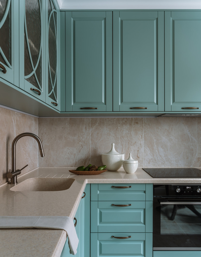 Inspiration for a mid-sized transitional l-shaped ceramic tile and beige floor eat-in kitchen remodel in Moscow with an undermount sink, raised-panel cabinets, turquoise cabinets, solid surface countertops, beige backsplash, stainless steel appliances and beige countertops