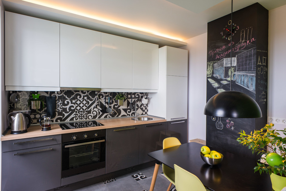 Design ideas for a contemporary grey and black single-wall kitchen/diner in Moscow with a built-in sink, flat-panel cabinets, wood worktops, multi-coloured splashback, ceramic splashback, concrete flooring and no island.