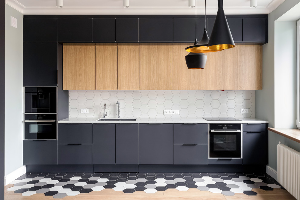 Medium sized scandinavian single-wall kitchen/diner in Moscow with a submerged sink, flat-panel cabinets, black cabinets, composite countertops, white splashback, ceramic splashback, black appliances, ceramic flooring, no island, white worktops and multi-coloured floors.