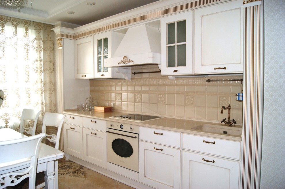 Example of a mid-sized classic kitchen design in Saint Petersburg with an integrated sink, solid surface countertops, beige backsplash, white appliances and no island