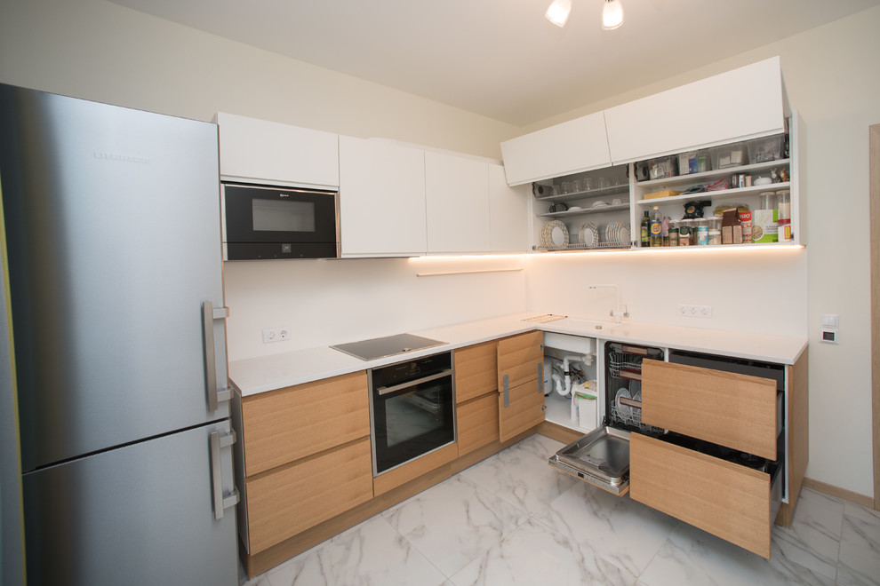 Medium sized scandi l-shaped enclosed kitchen in Moscow with a built-in sink, flat-panel cabinets, white cabinets, engineered stone countertops, white splashback, stone slab splashback, stainless steel appliances, marble flooring, no island and white floors.