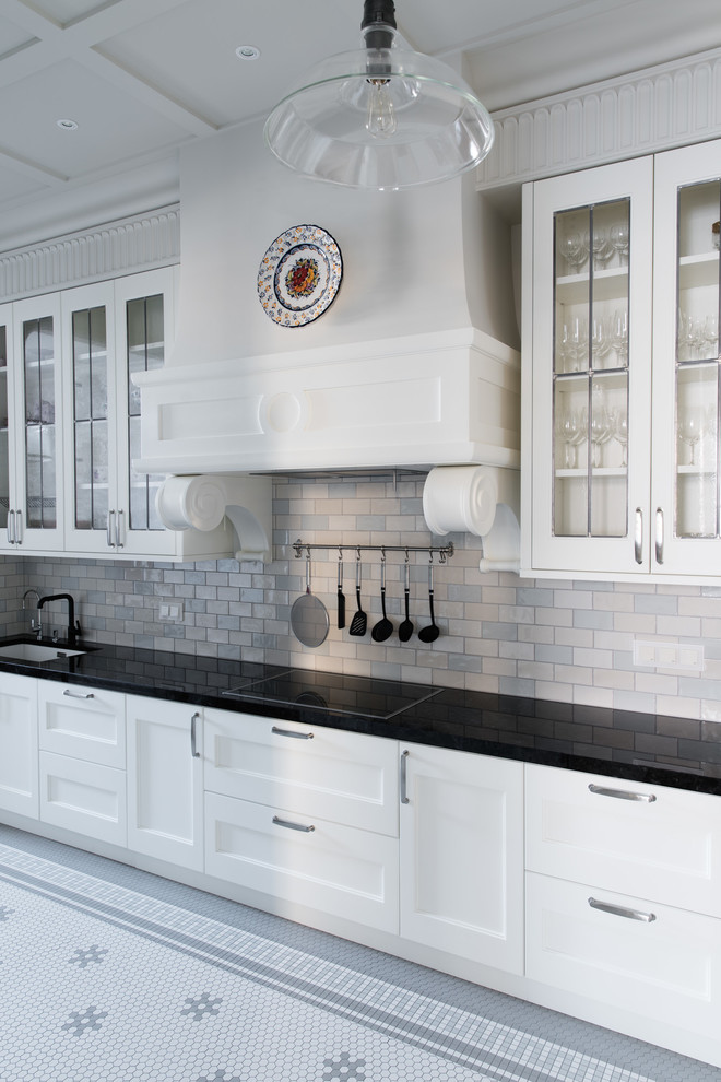 Inspiration for a timeless single-wall eat-in kitchen remodel in Moscow with an undermount sink, shaker cabinets, white cabinets, multicolored backsplash, subway tile backsplash, black appliances and black countertops