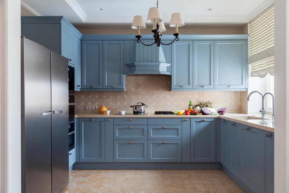 This is an example of a traditional l-shaped kitchen in Moscow with a submerged sink, recessed-panel cabinets, blue cabinets, beige splashback, black appliances and no island.