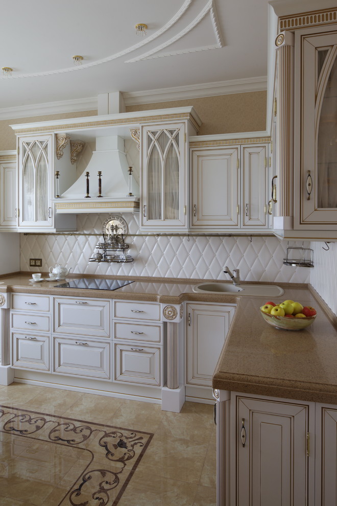 Inspiration for a medium sized traditional l-shaped enclosed kitchen in Moscow with raised-panel cabinets, white cabinets, engineered stone countertops, white splashback, terracotta splashback, white appliances, porcelain flooring, no island and a built-in sink.