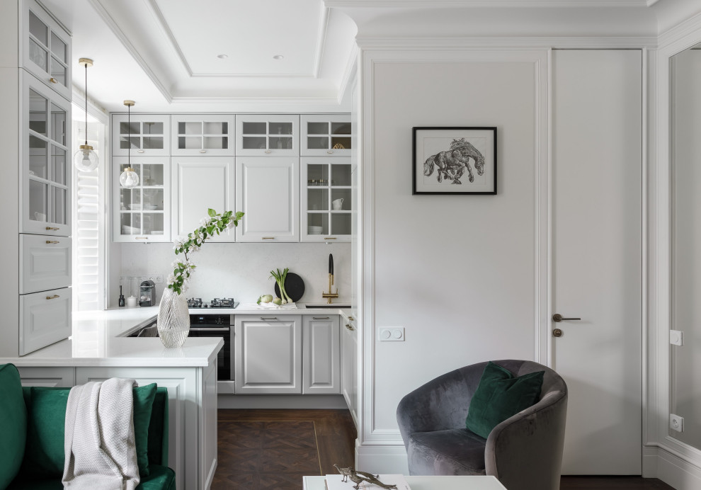 Inspiration for a medium sized scandinavian u-shaped open plan kitchen in Saint Petersburg with a submerged sink, recessed-panel cabinets, grey cabinets, engineered stone countertops, white splashback, engineered quartz splashback, black appliances, vinyl flooring, a breakfast bar, brown floors and white worktops.