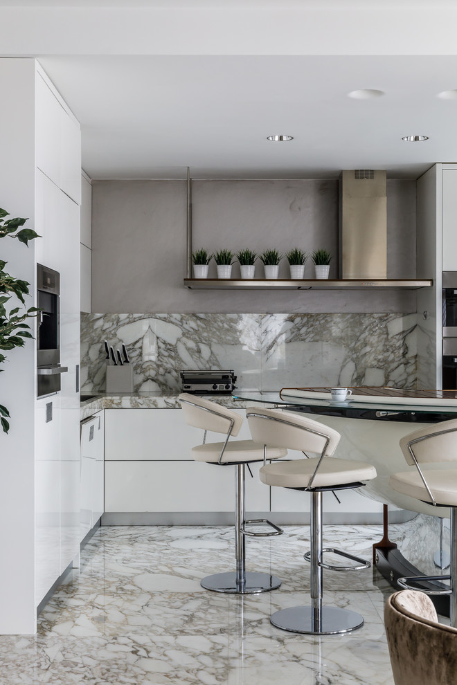 Photo of a contemporary l-shaped open plan kitchen in Other with a built-in sink, flat-panel cabinets, white cabinets, marble worktops, beige splashback, marble splashback, stainless steel appliances, marble flooring, beige floors and beige worktops.