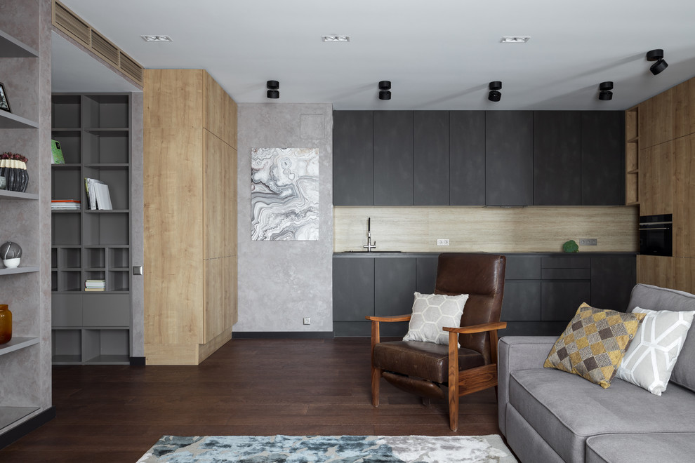 Large contemporary single-wall open plan kitchen in Moscow with flat-panel cabinets, grey cabinets, quartz worktops, beige splashback, porcelain splashback, no island, brown floors, grey worktops, black appliances and dark hardwood flooring.