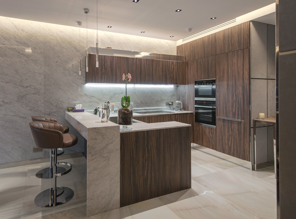 Inspiration for a contemporary u-shaped open plan kitchen in Moscow with a built-in sink, flat-panel cabinets, dark wood cabinets, grey splashback, stainless steel appliances, a breakfast bar, beige floors and grey worktops.