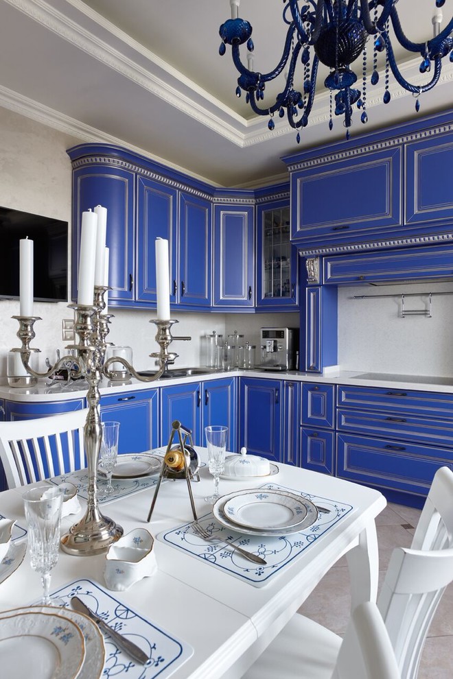 This is an example of a classic l-shaped enclosed kitchen in Moscow with a built-in sink, raised-panel cabinets, blue cabinets, beige splashback and no island.