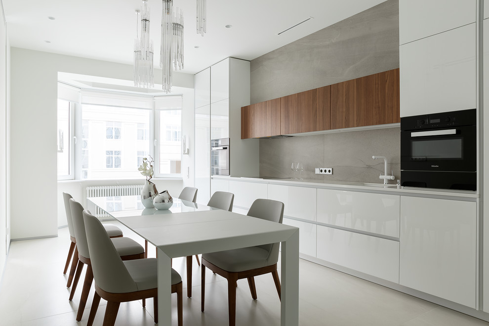 Design ideas for a medium sized contemporary single-wall kitchen/diner in Saint Petersburg with a submerged sink, flat-panel cabinets, white cabinets, grey splashback, porcelain splashback, black appliances, porcelain flooring, no island, grey floors and white worktops.