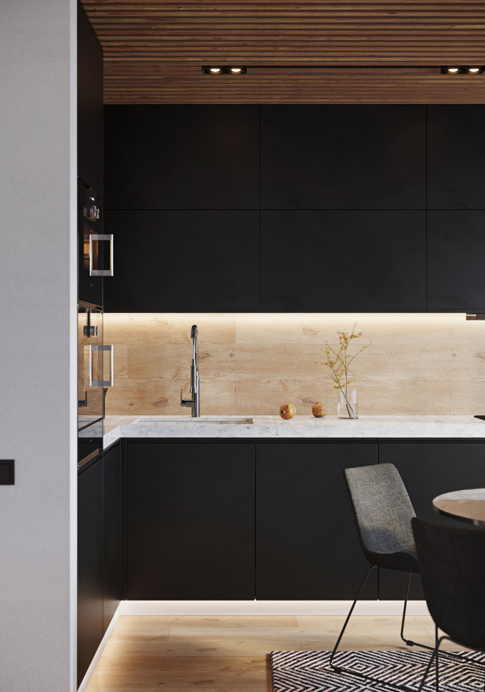 Photo of a small contemporary l-shaped kitchen/diner in Valencia with an integrated sink, flat-panel cabinets, black cabinets, marble worktops, beige splashback, porcelain splashback, black appliances, porcelain flooring, beige floors and white worktops.