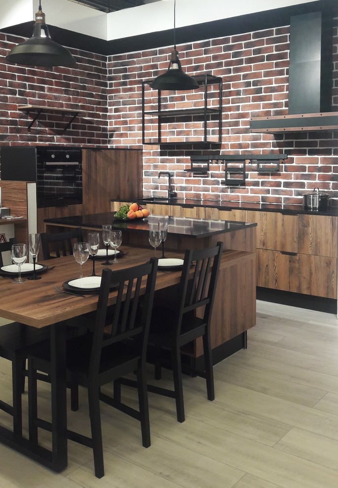 Example of a mid-sized urban l-shaped laminate floor eat-in kitchen design in Saint Petersburg with a single-bowl sink, flat-panel cabinets, medium tone wood cabinets, quartz countertops, brick backsplash, black appliances, an island and black countertops