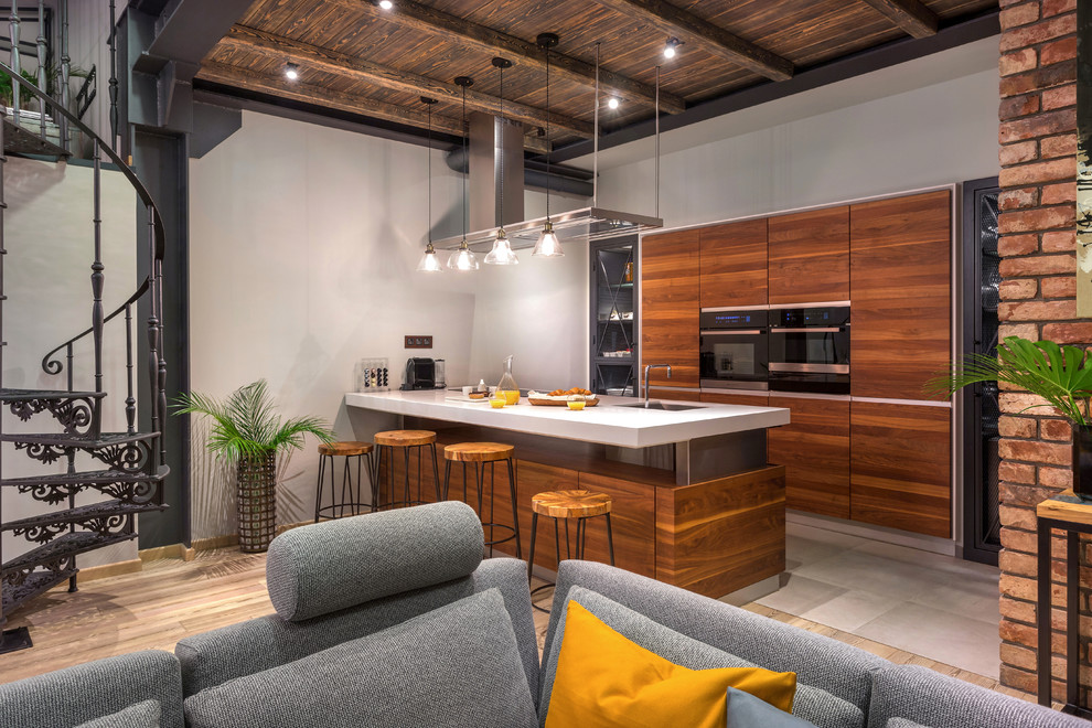 Design ideas for an urban galley open plan kitchen in Moscow with a submerged sink, flat-panel cabinets, medium wood cabinets, stainless steel appliances, an island, grey floors and white worktops.