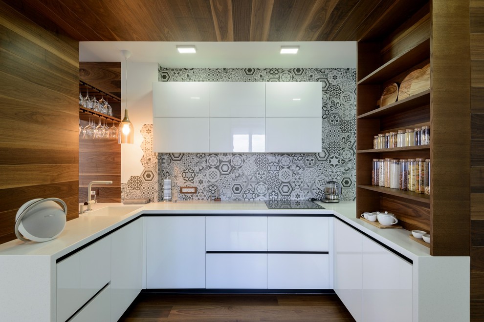 Open concept kitchen - contemporary u-shaped medium tone wood floor and brown floor open concept kitchen idea in Moscow with an integrated sink, flat-panel cabinets, white cabinets, gray backsplash and no island