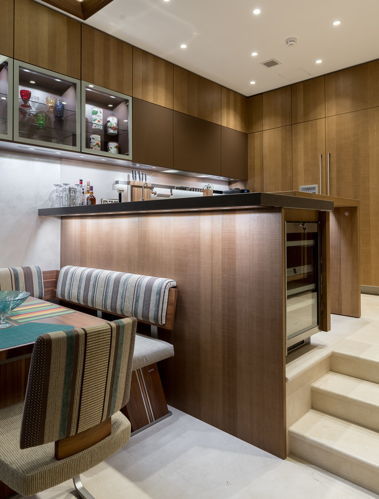 Contemporary u-shaped kitchen in Moscow with flat-panel cabinets, medium wood cabinets, white splashback and a breakfast bar.
