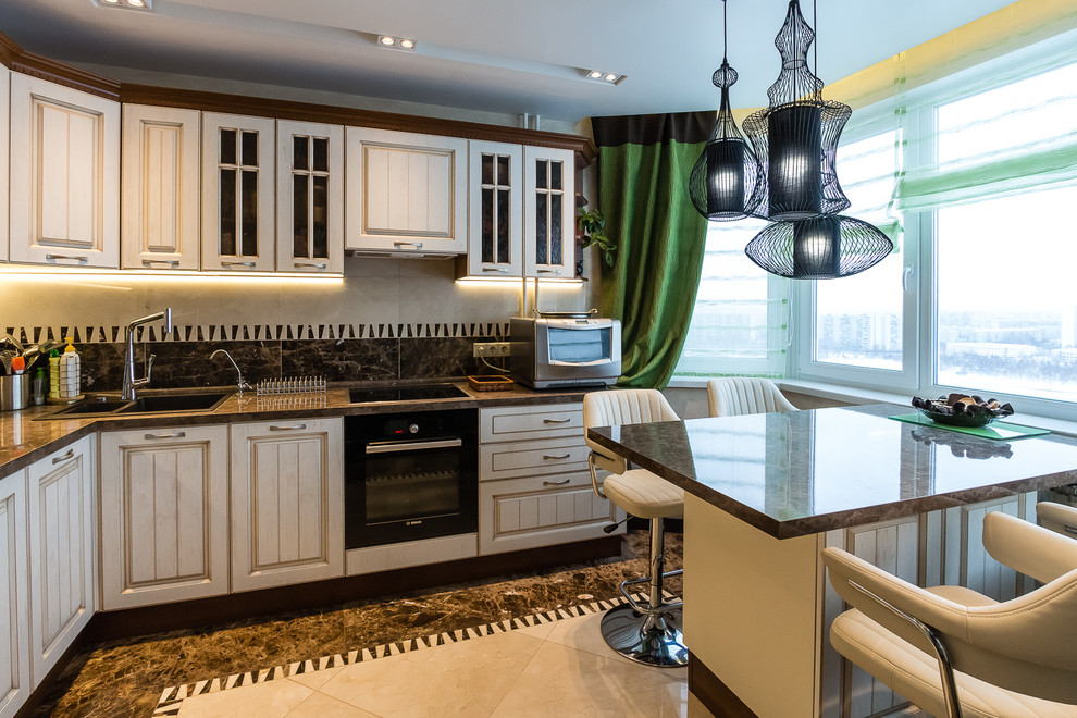 Classic l-shaped kitchen in Moscow with a double-bowl sink, white cabinets, black appliances, an island, glass-front cabinets and multi-coloured splashback.