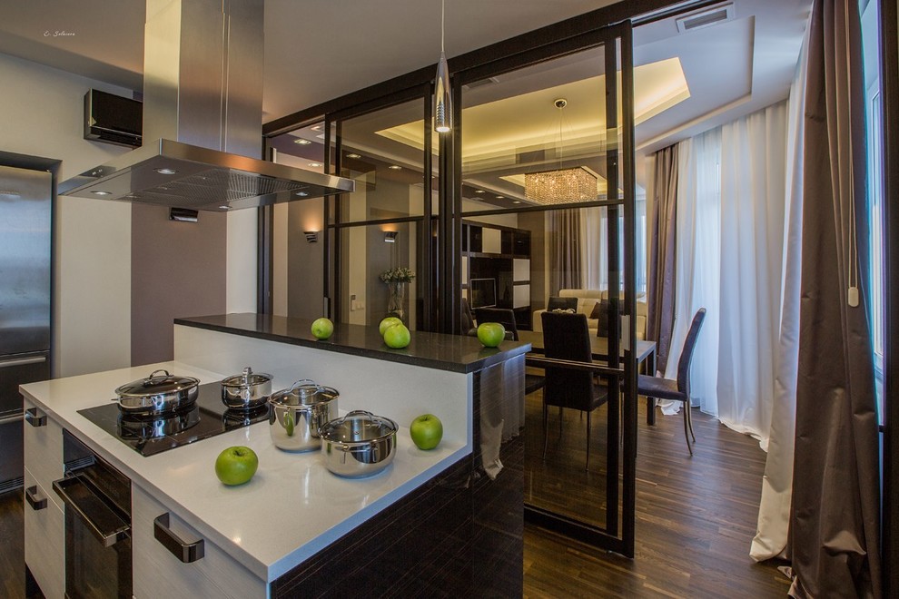 Inspiration for a medium sized contemporary kitchen/diner in Moscow with dark wood cabinets, white splashback and brown floors.