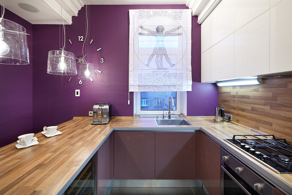 Example of a trendy u-shaped open concept kitchen design in Saint Petersburg with a drop-in sink, flat-panel cabinets, brown backsplash, stainless steel appliances and a peninsula