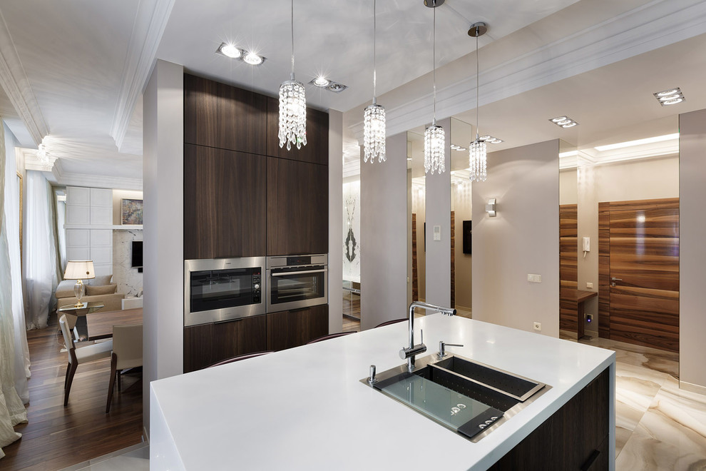 This is an example of a large contemporary galley open plan kitchen in Saint Petersburg with composite countertops, white splashback, an island, a submerged sink, flat-panel cabinets, dark wood cabinets, stone slab splashback, stainless steel appliances and ceramic flooring.