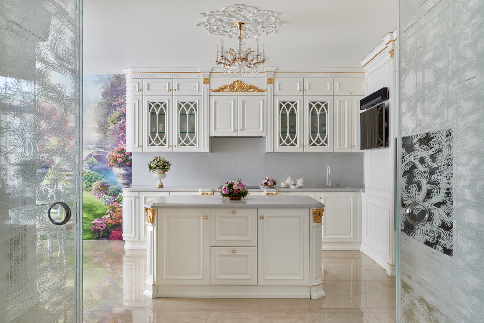 Large traditional l-shaped kitchen/diner in Moscow with a submerged sink, raised-panel cabinets, white cabinets, marble worktops, white splashback, marble splashback, black appliances, marble flooring, an island and beige floors.