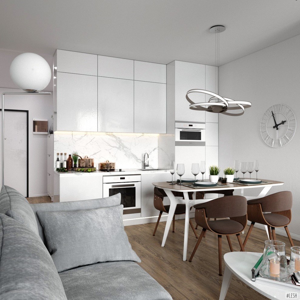 Photo of a medium sized contemporary single-wall open plan kitchen in Saint Petersburg with a submerged sink, flat-panel cabinets, white cabinets, marble worktops, beige splashback, marble splashback, white appliances, laminate floors, no island, brown floors and white worktops.