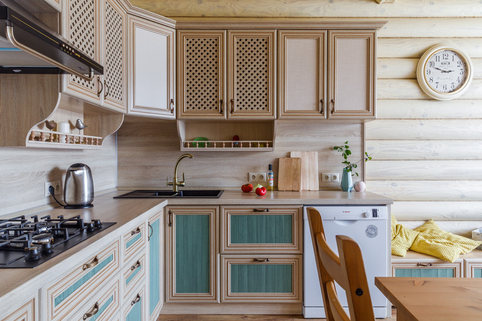 Design ideas for a rural l-shaped kitchen/diner in Other with a built-in sink, recessed-panel cabinets, light wood cabinets, wood worktops, white appliances, medium hardwood flooring, no island, brown floors and beige splashback.