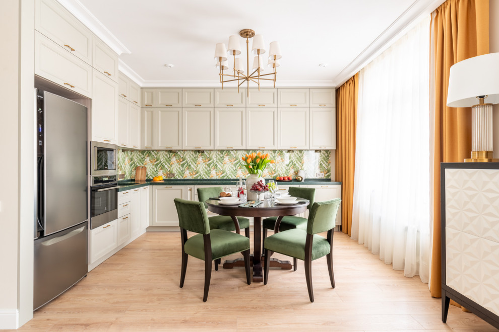 This is an example of a large classic l-shaped kitchen/diner in Moscow with a submerged sink, raised-panel cabinets, beige cabinets, composite countertops, green splashback, glass sheet splashback, stainless steel appliances, medium hardwood flooring, no island, beige floors and green worktops.