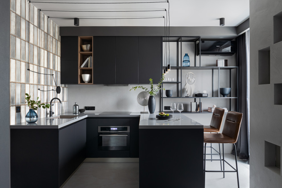 Inspiration for a contemporary u-shaped kitchen in Saint Petersburg with a submerged sink, black cabinets, white splashback, stainless steel appliances, a breakfast bar, white floors and white worktops.