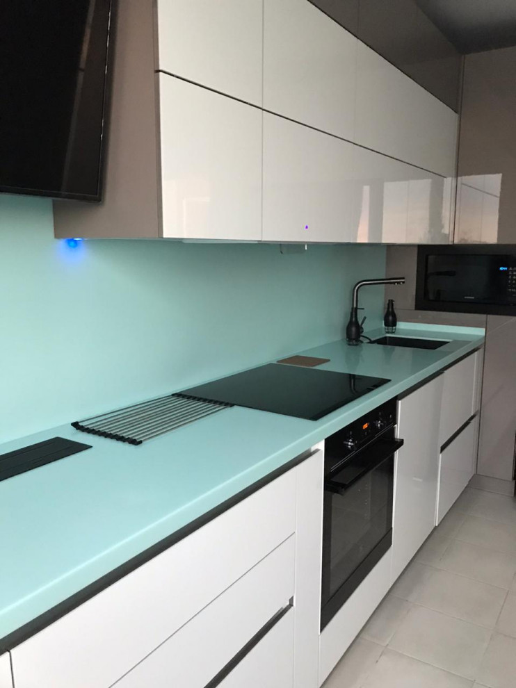 This is an example of a small contemporary single-wall kitchen/diner in Saint Petersburg with composite countertops, green splashback and green worktops.