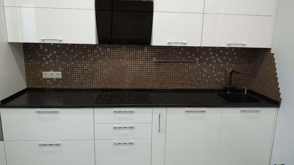 Design ideas for a small contemporary single-wall enclosed kitchen in Moscow with a submerged sink, flat-panel cabinets, white cabinets, composite countertops, brown splashback, ceramic splashback, black appliances, no island and black worktops.